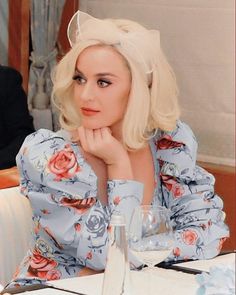 a woman with blonde hair sitting at a table