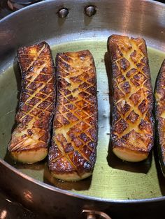 four pieces of food cooking in a pan