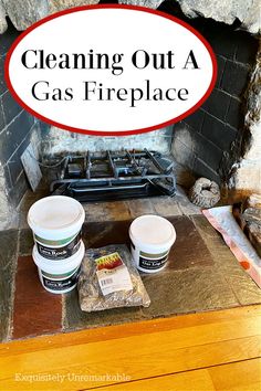 cleaning out a gas fireplace with two buckets