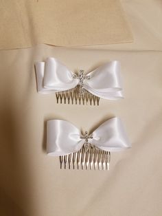 "THESE SATIN BOWS ARE GREAT FOR FIRST COMMUNION, CONFIRMATION, WEDDINGS OR FOR *BAPTISM (*SMALLER IF, NEEDED) First Quality double face ribbon. BOW DIMENSIONS: SMALL CROSS BOW: Bow 4.5\" x 1.5\" metal comb: 2.5\", cross: 1\" MEDIUM CROSS BOW: 5 1/4\" X 1\" metal comb: 2.5\", cross: 1 1/2\" COLORS: WHITE, OR IVORY I'm a Bridal Accessories Designer, but... Because girls deserve to be and to look amazing from the minute they're born, I have designed a full line of beautiful little, and big girls ha Cross Bow Accessories, Adjustable Bow Hair Accessories For Wedding, Adjustable Butterfly Knot Bow For Wedding, Adjustable Wedding Hair Accessories With Satin Bow, Adjustable Satin Bow Hair Accessories For Wedding, Adjustable Wedding Hair Accessories With Decorative Bow, Adjustable White Bow For Wedding, White Bow Hair Accessory For Wedding, Cute White Bow Tie Hair Accessories