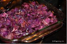 a glass dish filled with red cabbage on top of a stove