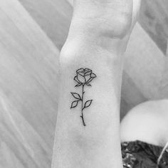 a small rose tattoo on the wrist