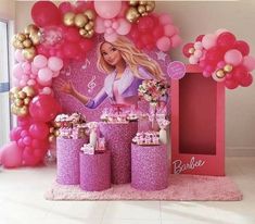 a barbie birthday party with pink and gold balloons