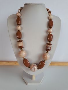 very beautiful piece! Vintage Retro chunky milk chocolate brown and swirl milk chocolate brown and biege lucite plastic beaded necklace with gold metal accent and different shapes and sizes of beads with lustrous surface with no seems and claps.  Circa 1975-1980. length: 24.5 inches; biggest ball beads: 7/8 inches diameter. good condition  To make this a smooth and pleasant transaction experience for everyone, all buyers need to read and understand the description, the terms of sale , the payment and the shipping indicated in this listing. Return not accepted - please ask before purchase. Thank you for watching our other items! A large collection of unique and unusual vintage items is listed. Plastic Necklace, Chunky Bead Necklaces, Chunky Beads, Vintage Lucite, Creative Jewelry, Bead Jewellery, Plastic Beads, Necklace Vintage, Metallic Accents