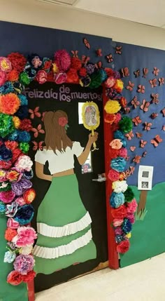 a door decorated with paper flowers and a woman holding a mirror in front of it