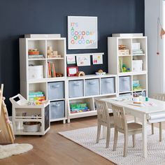 a child's playroom with toys, bookshelves and storage bins