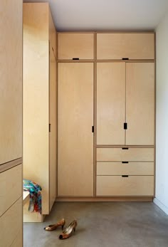 the closets are made of plywood and have shoes on the floor next to them