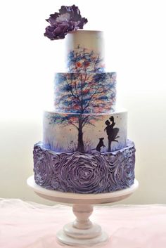 a three tiered cake with an artistic design on it