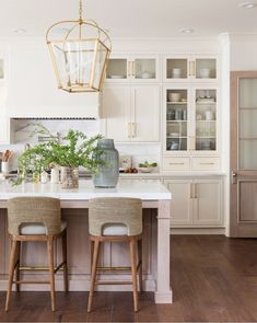 two stools sit at the center of a kitchen island