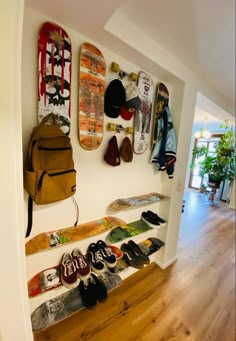 there are many skateboards on the wall and in the hallway, as well as shoes