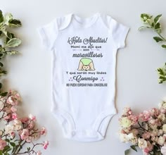 a baby bodysuit with the words, mama we do our mardi gras