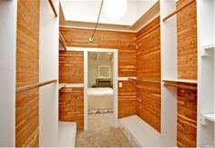 an empty room with wood paneling on the walls