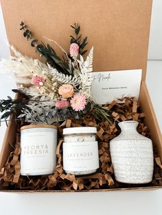 an open box containing candles and flowers