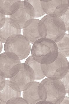 an abstract pattern made up of circles on a white background with gray and pink tones