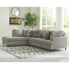 a living room with a sectional couch and rug