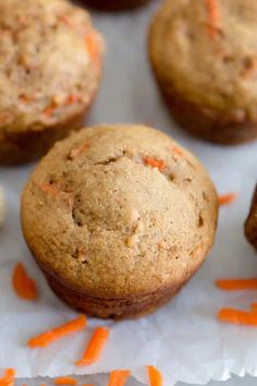 carrot muffins sitting on top of white paper