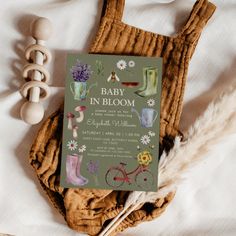 a baby in bloom book sitting on top of a bed