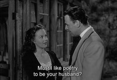 a man and woman standing next to each other in front of a wooden structure with the words must i like poetry to be your husband?