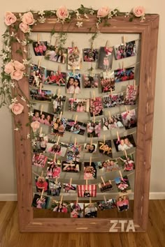 a wooden frame filled with pictures and flowers