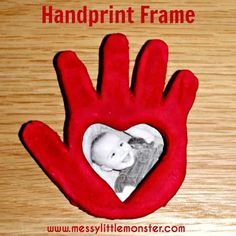 a red handprint frame with a baby's photo in the heart on it