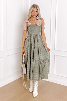 - Twirl into a perfect day with this charming midi dress! Its delightful floral print and smocked bodice bring a touch of sweetness, while the tied straps add a darling detail. Effortless style and carefree moments await! - Unlined material with appetite floral print featuring ivory, green, and pink hues - A square cut neckline with ruffle detailing - Tied straps - A smocked bodice - An elastic waistline - Ruffle detailing - A flowy yet flattering silhouette that ends in a straight midi length h Spring Sundress With Smocked Tie Straps, Spring Smocked Sundress With Tie Straps, Green Spring Midi Dress With Ruffled Straps, Green Midi Dress With Ruffled Straps For Spring, Spring Smocked Midi Dress With Tie Straps, Chic Smocked Dress With Tie Straps For Spring, Spring Brunch Smocked Dress With Tie Straps, Chic Smocked Midi Dress With Tie Straps, Chic Midi Length Smocked Dress With Tie Straps