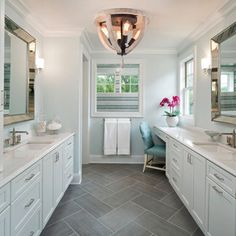 a large bathroom with two sinks and mirrors