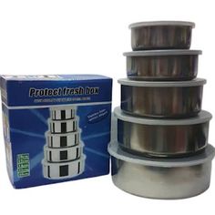 four stacks of stainless steel containers stacked on top of each other in front of a box