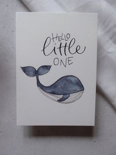 there is a card with a drawing of a whale and the words hello little one on it