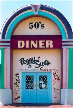 an entrance to a diner with blue doors