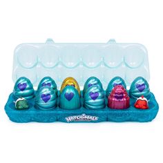 an egg carton filled with lots of different types of eggs in blue and pink