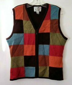 a multicolored vest hanging on a white wall