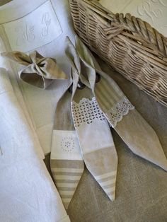 some folded towels are laying on the floor next to a wicker basket and pillow