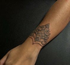 a person's arm with a tattoo on it, which has an ornate design