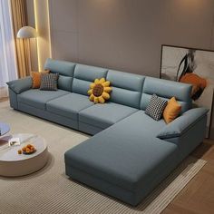 a living room with a blue couch and coffee table in front of a large window