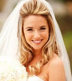 a beautiful blonde bride holding a bouquet of flowers