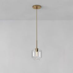 a light fixture hanging from the ceiling in a room with white walls and flooring