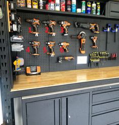 there are many tools on the wall in this garage