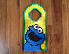 an image of a cell phone case made out of legos on wood flooring