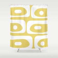 a yellow and white shower curtain with circles on it