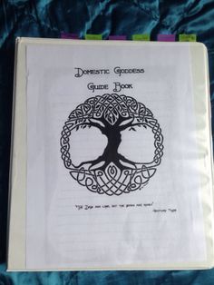 a book with an image of a tree in the middle and celtic writing on it