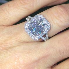 a woman's hand with a diamond ring on it and an engagement band around her finger