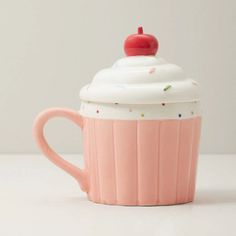 a pink cupcake mug with a cherry on top