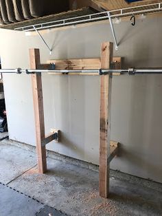 a wooden rack with two metal bars attached to it