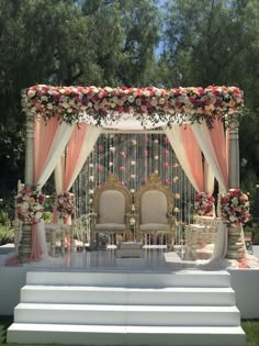 an outdoor wedding setup with chairs and flowers