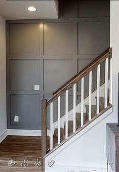 an empty living room with stairs leading up to the second floor and a tv on top of a dresser