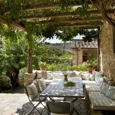 an outdoor dining area with table and chairs