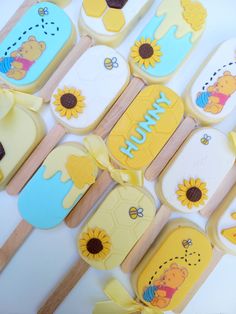 winnie the pooh cupcakes are decorated with fondant and sunflowers