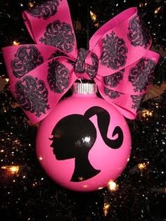 a pink ornament with a black bow on it