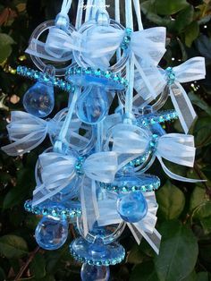 a blue and white ornament hanging from a tree