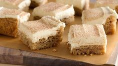 several pieces of cake sitting on top of a cutting board